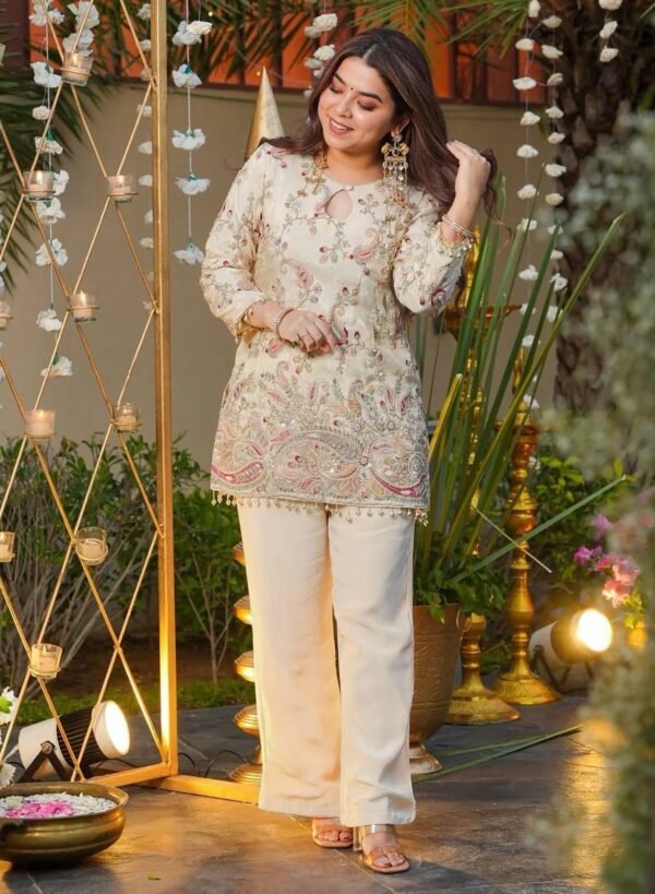 Cream heavy embroidered crepe silk kurti with matching pant, front view
