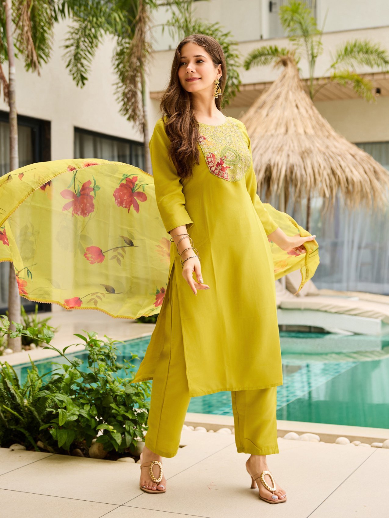 The sheer floral printed dupatta held open beside the lime green kurta