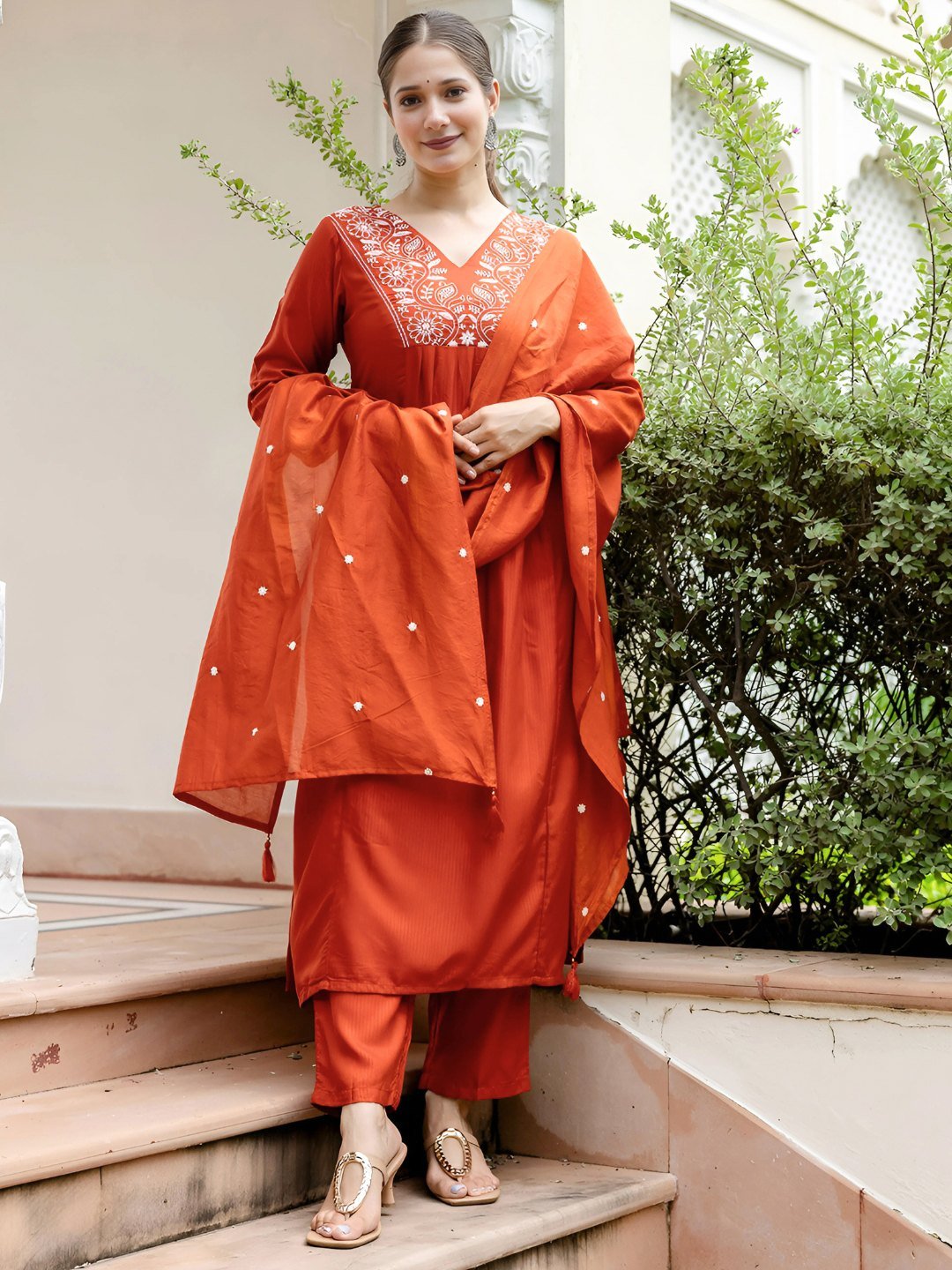 Front view of the rust kurta set with the dupatta over one shoulder