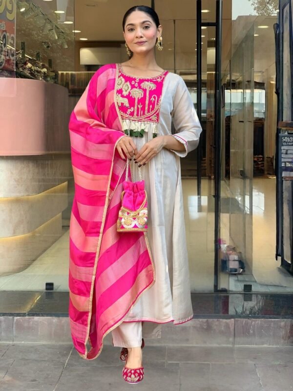 Pink embroidered yoke off-white silk kurta with matching pant and jacquard dupatta, front view