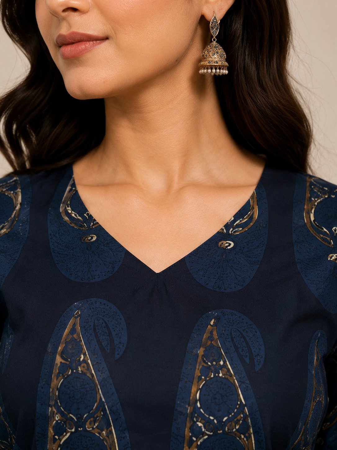 Close-up of the V-neckline and gold foil paisley print on the navy kurta