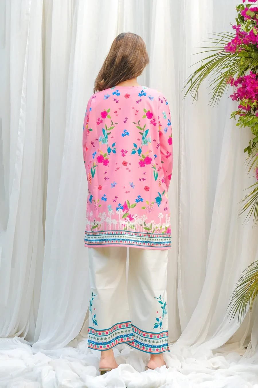 Back view of the pink floral print kurti and cream pant