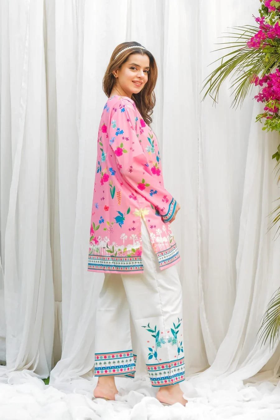 Side view of the pink printed kurti with cream straight pant