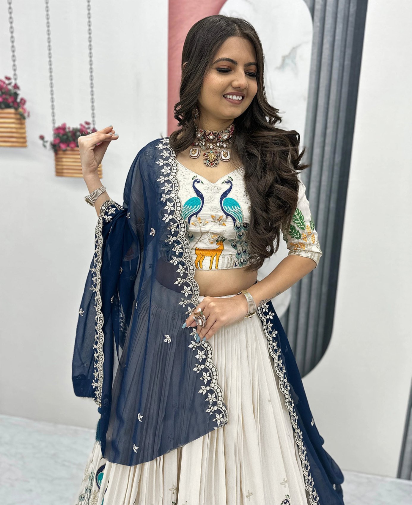 Ivory lehenga choli styled with the contrast navy dupatta