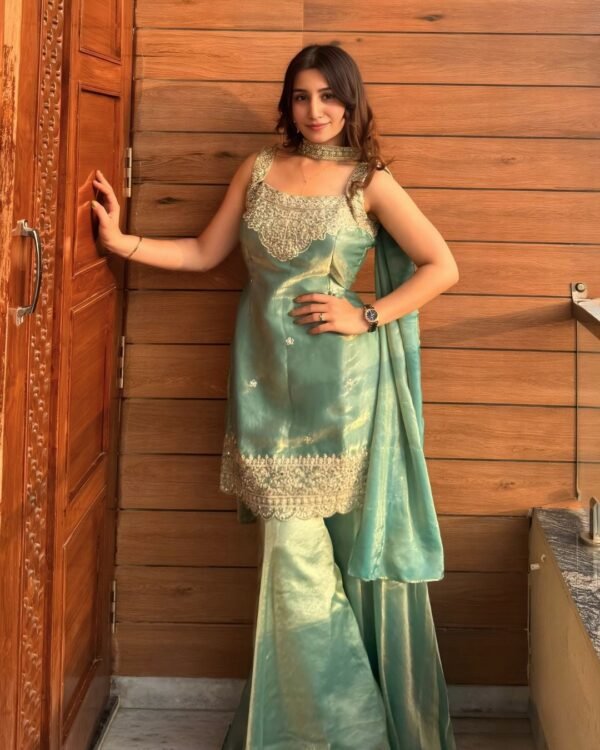 Model wearing the firozi sequin embroidered top, sharara & dupatta set, front view