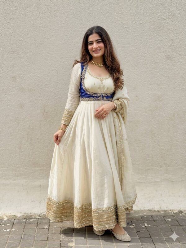 Model wearing the white embroidered Chinnon kurta, pant and dupatta set with a blue contrast waist, front view