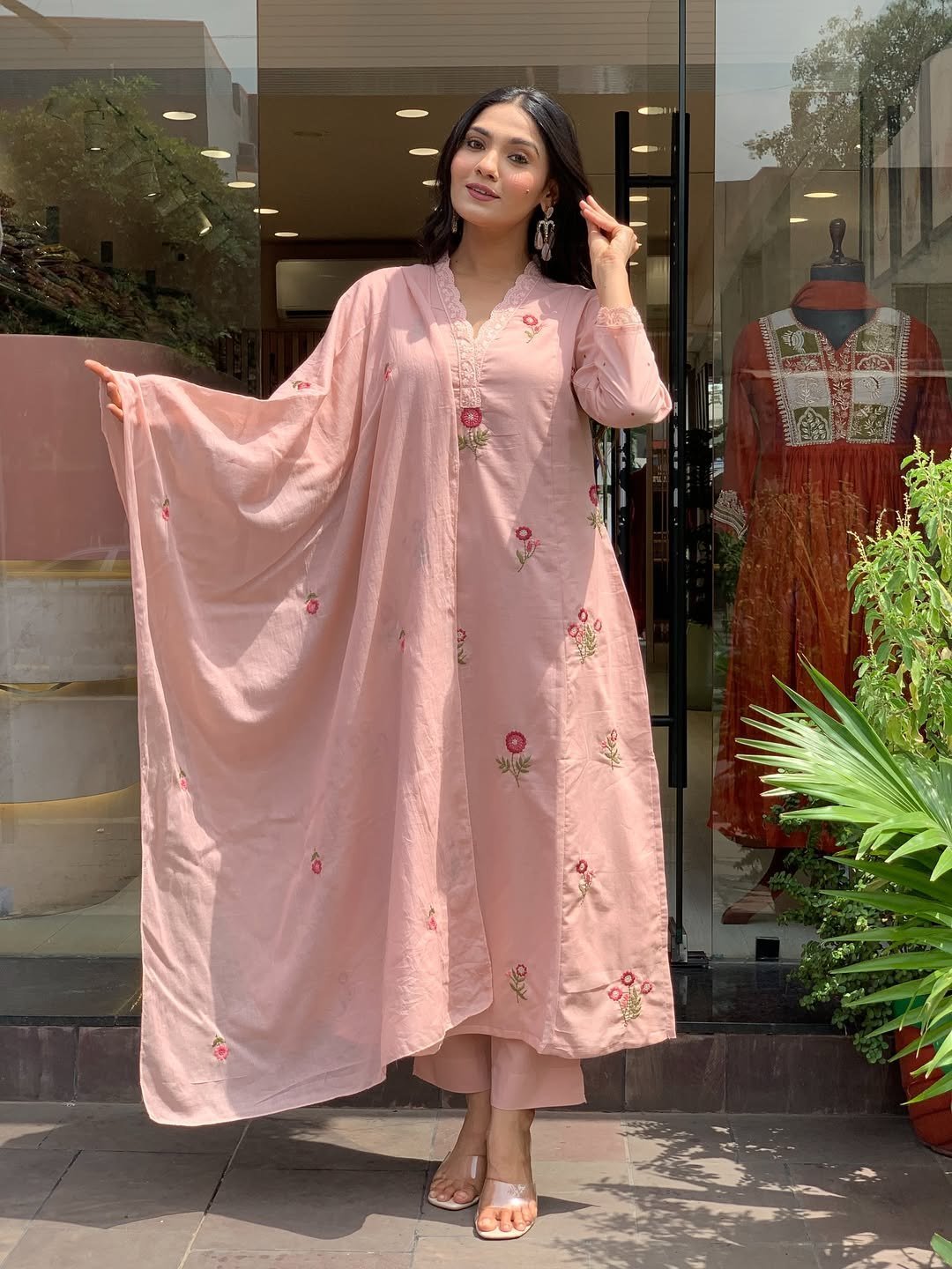 The sheer Chanderi dupatta held open beside the peach kurta