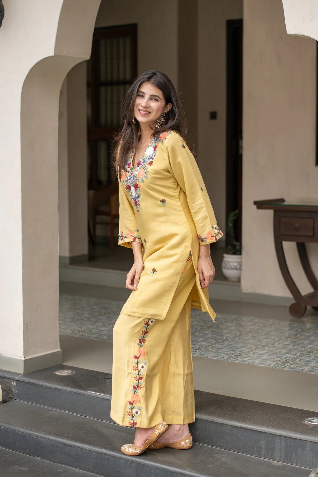 Side view of the yellow embroidered kurti with matching pant