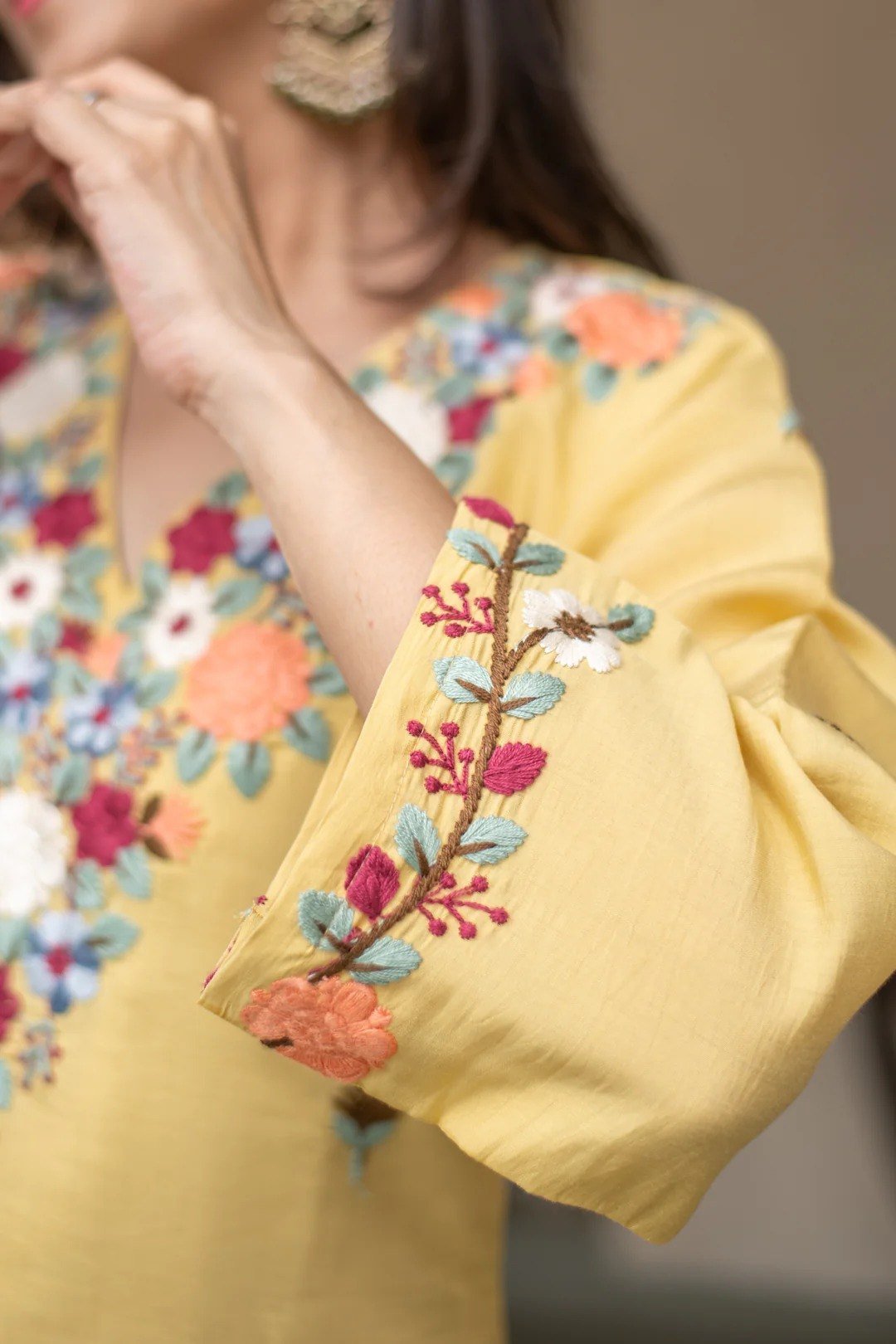 Close-up of the embroidered sleeve cuff on the yellow kurti