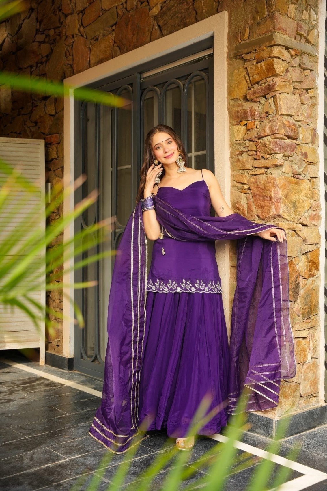 The sheer organza dupatta with gold zari stripes held open