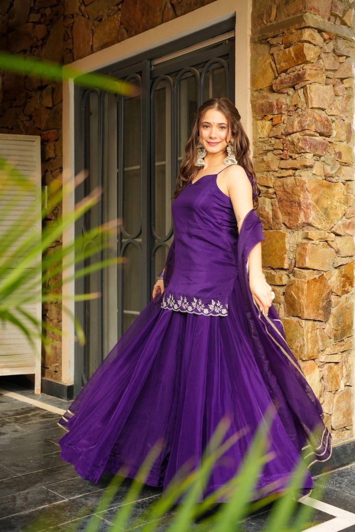Front view of the purple top and flared palazzo set