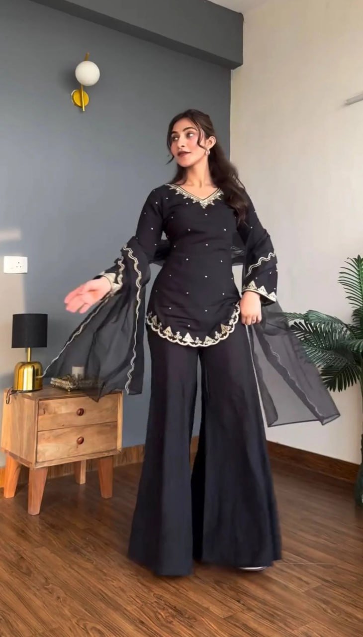 Model twirling the black organza dupatta with scalloped embroidered border, kurta set front view