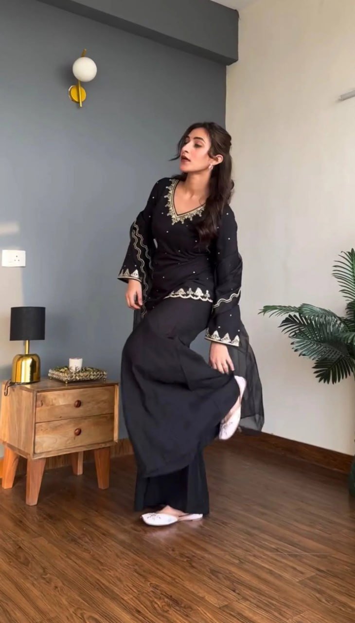 Black embroidered kurta and wide-leg pant set, side pose