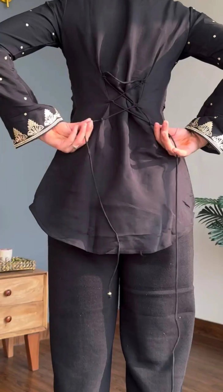 Back view of black silk crepe kurta with lace-up dori tie at the waist